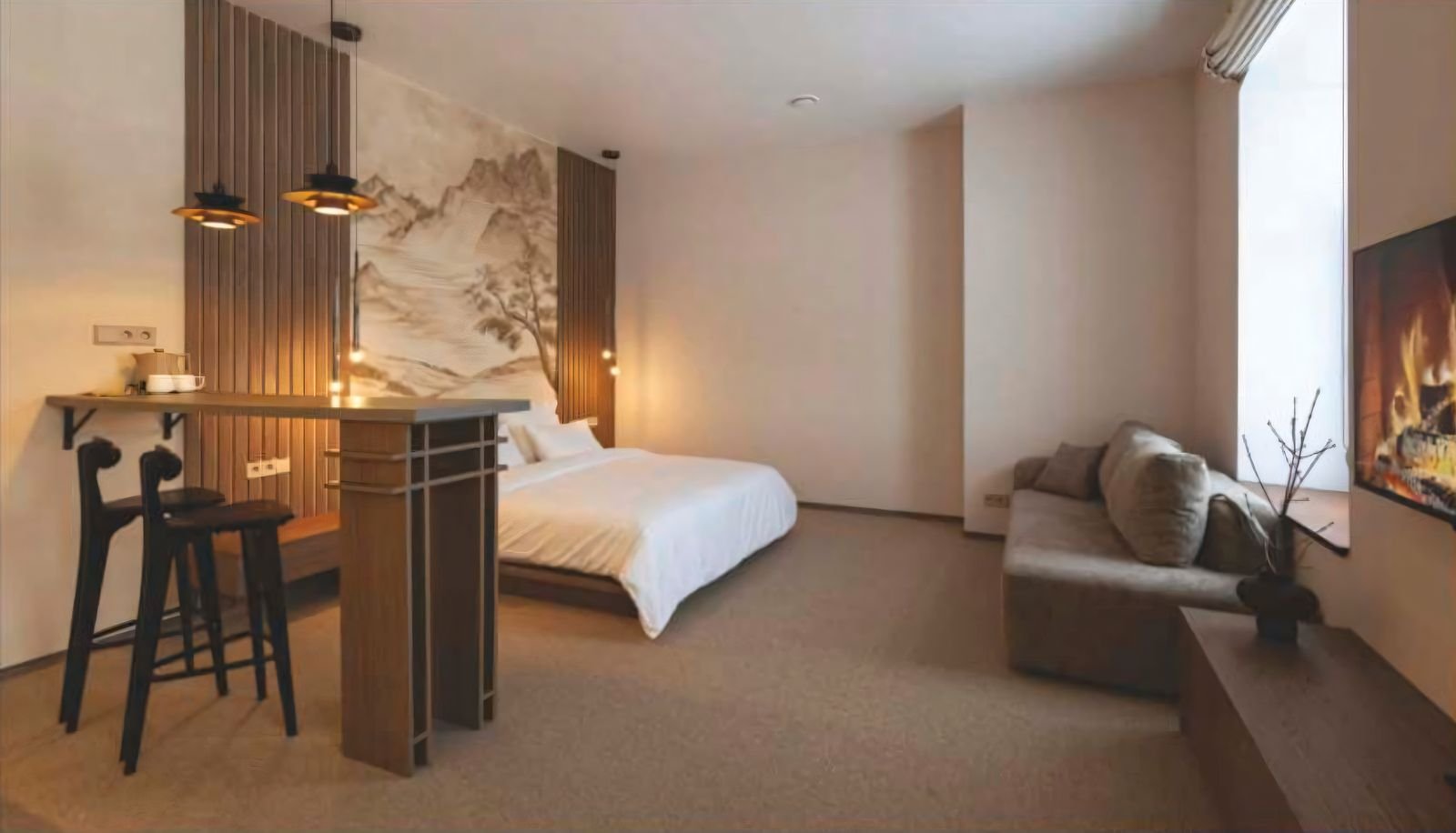 Furnished corporate studio suite interior — bedroom and lounge area with smart-home fittings